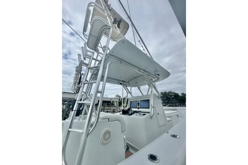 Slide: The Image of 2004 Yellowfin 36 Offshore boat with tower and helm, under cloudy sky. - 22