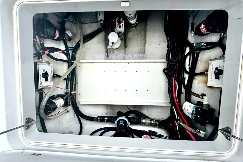 Slide: The Image of 2004 Yellowfin 36 Offshore boat compartment with wiring and mechanical components. - 23