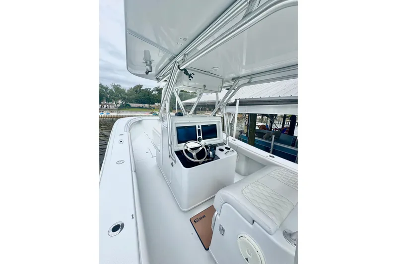 Slide: The Image of 2004 Yellowfin 36 Offshore boat on calm water, cityscape in background. - 3