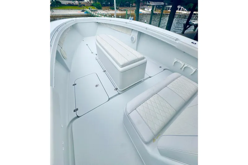 Slide: The Image of 2004 Yellowfin 36 Offshore boat named "Knotty Girl" on calm water. - 5