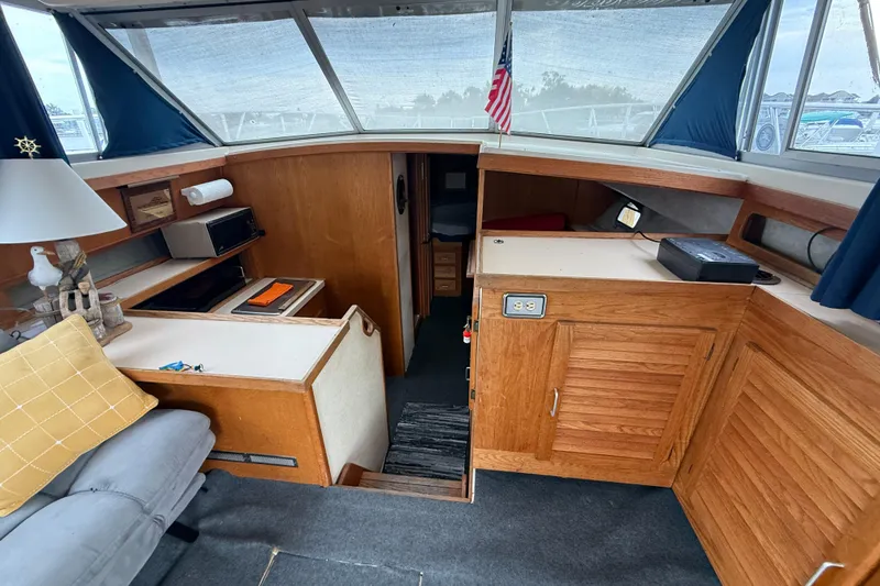 Slide: The Image of 1986 Silverton 34 Convertible interior with wood cabinetry and nautical decor. - 12