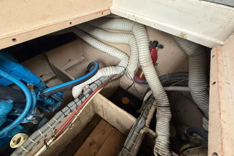Slide: The Image of Engine compartment of a 1986 Silverton 34 Convertible boat with hoses and wiring. - 15