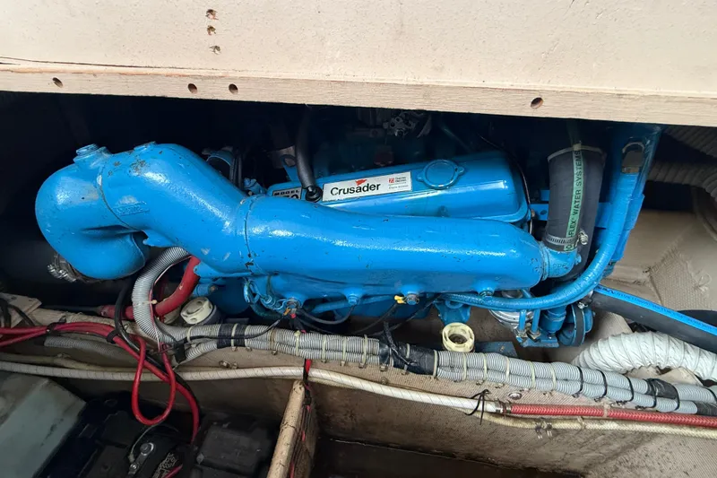 Slide: The Image of Engine compartment of a 1986 Silverton 34 Convertible boat with blue Crusader engine. - 17