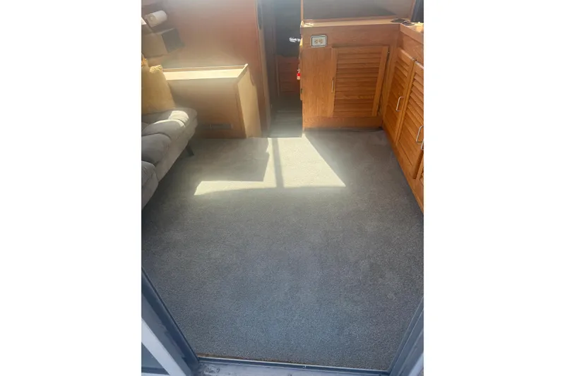 Slide: The Image of Interior of 1986 Silverton 34 Convertible with carpet and wooden cabinetry. - 2