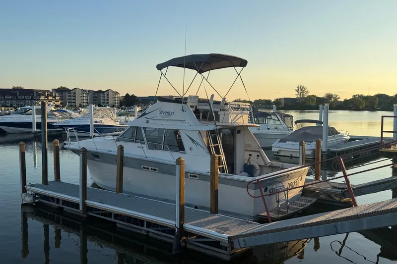 Slide: The Image of 1986 Silverton 34 Convertible docked at marina during sunset. - 26