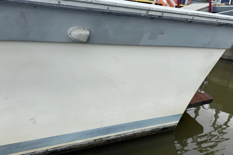 Slide: The Image of 1986 Silverton 34 Convertible boat hull, docked in calm water. - 5