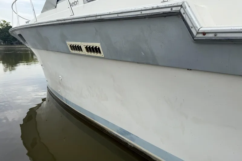 Slide: The Image of 1986 Silverton 34 Convertible boat side view on calm water. - 6