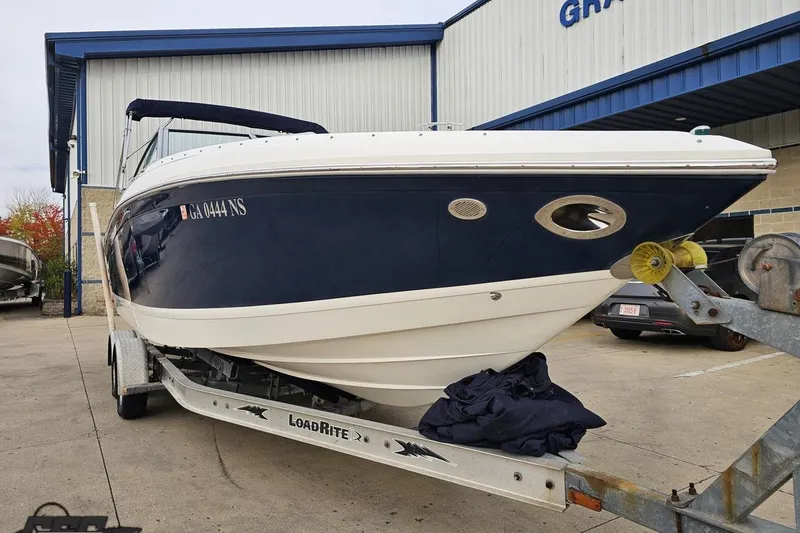 Slide: The Image of 2007 Cobalt 252 boat on trailer outside a building, ready for transport. - 13