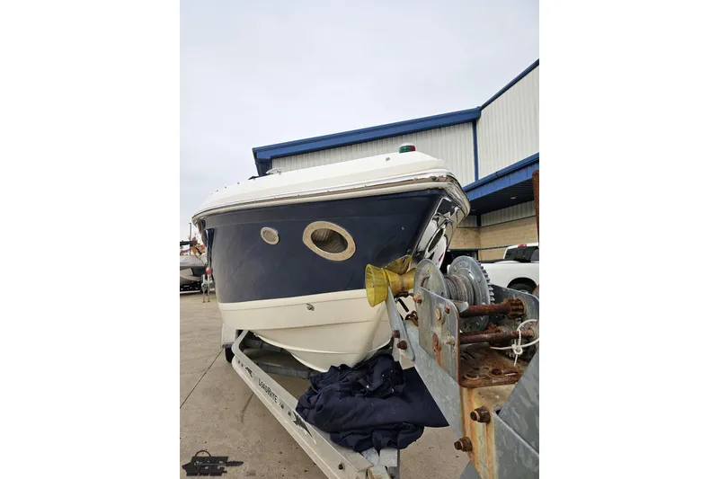 Slide: The Image of 2007 Cobalt 252 boat on trailer, parked outside a warehouse. - 14