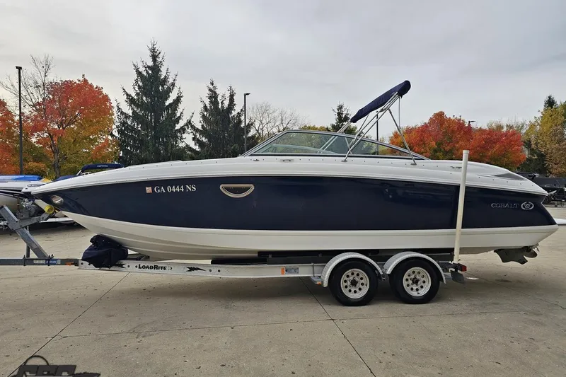 Slide: The Image of 2007 Cobalt 252 boat on trailer, autumn trees in background. - 20