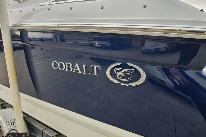 Slide: The Image of 2007 Cobalt 252 boat with logo on sleek blue hull. - 25