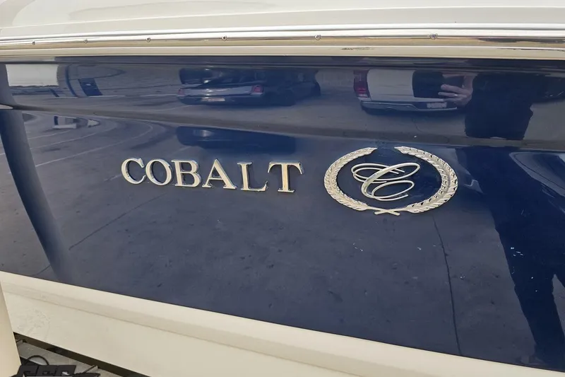 Slide: The Image of 2007 Cobalt 252 boat emblem on a glossy blue surface. - 26
