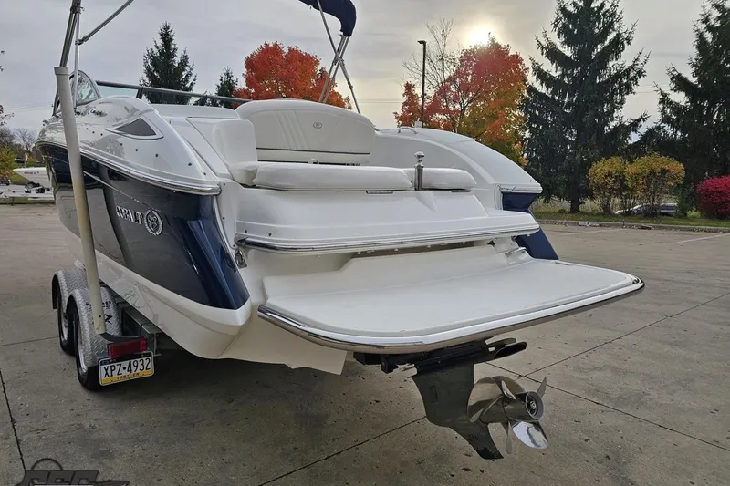Slide: The Image of 2007 Cobalt 252 boat on trailer, rear view, with autumn trees in the background. - 29