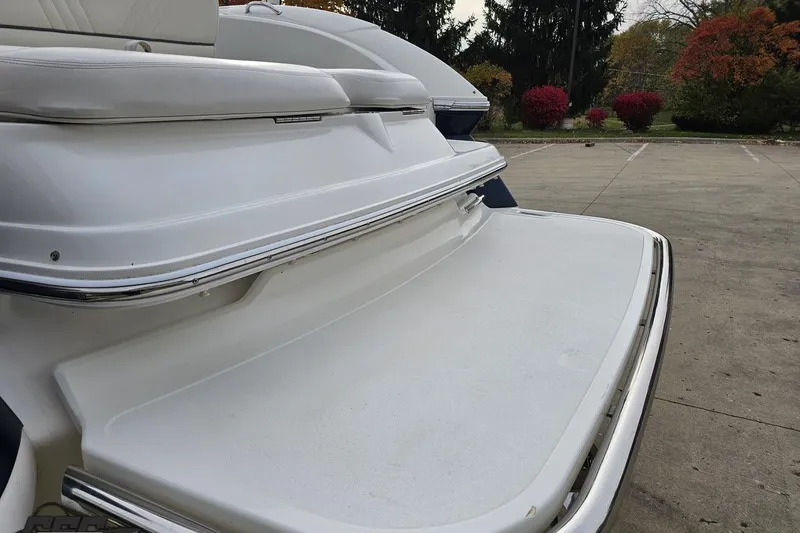 Slide: The Image of 2007 Cobalt 252 boat swim platform with white seating, parked outdoors. - 31