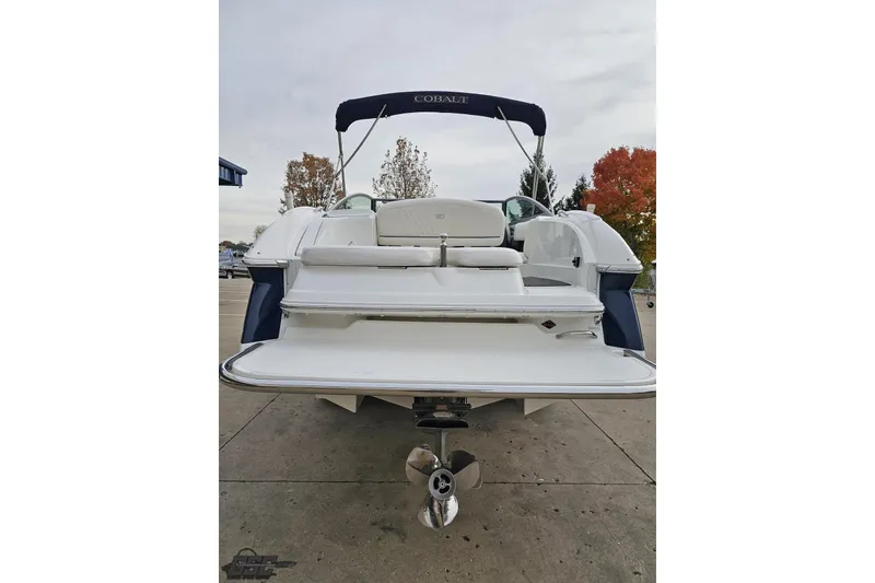 Slide: The Image of 2007 Cobalt 252 boat, rear view with swim platform and propeller, parked outdoors. - 33