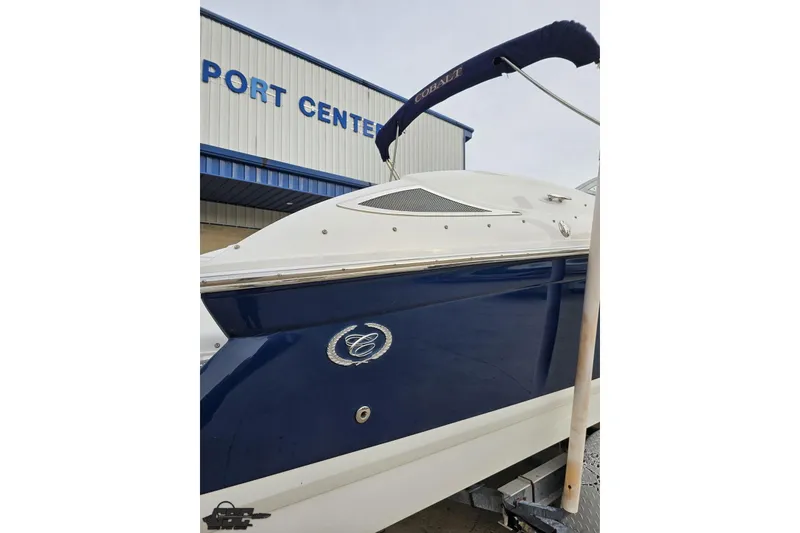 Slide: The Image of 2007 Cobalt 252 boat with blue and white exterior at a port center. - 36