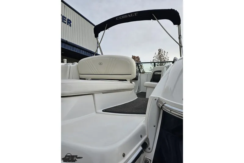 Slide: The Image of 2007 Cobalt 252 boat interior with white seating and canopy. - 38