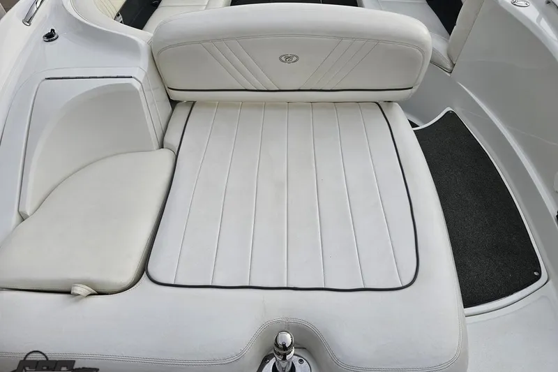 Slide: The Image of 2007 Cobalt 252 boat interior with white cushioned seating and sleek design. - 44