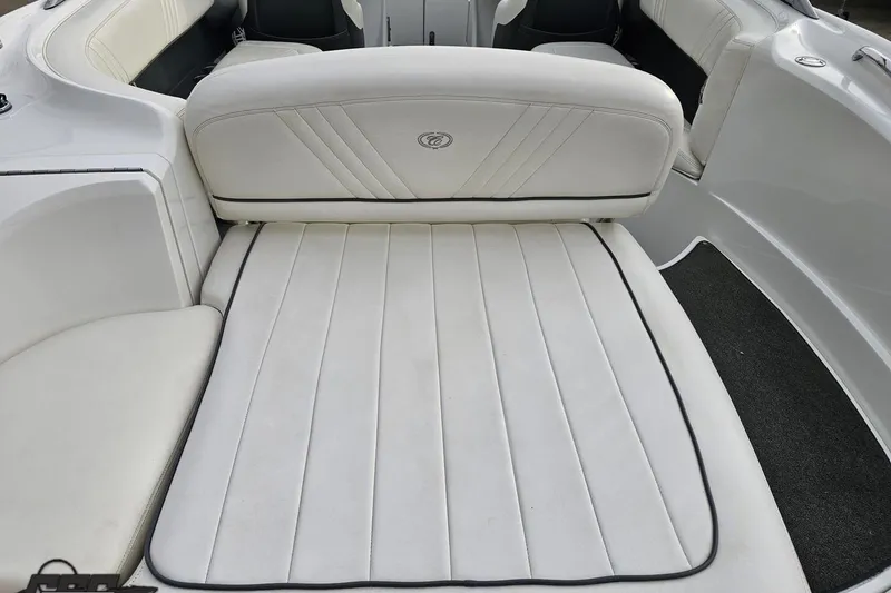 Slide: The Image of 2007 Cobalt 252 boat interior with white cushioned seating and sleek design. - 49