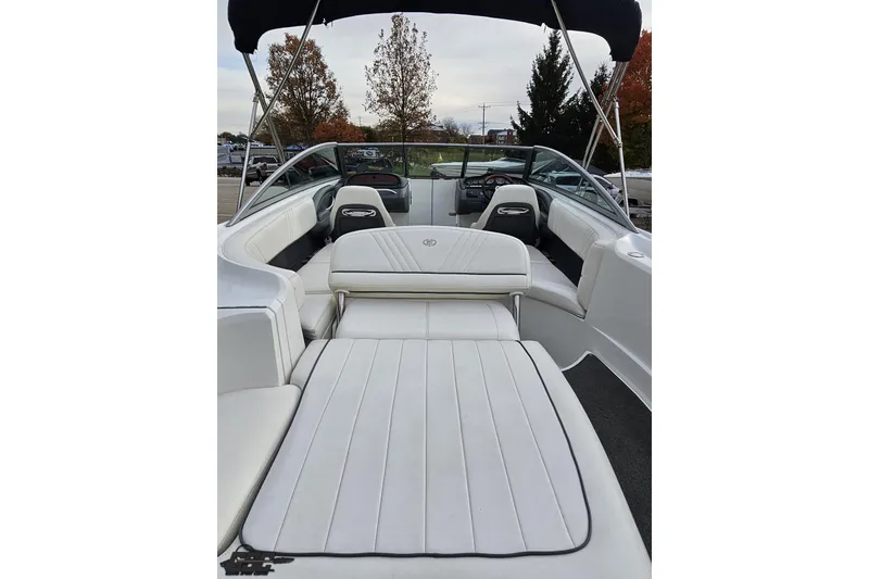 Slide: The Image of 2007 Cobalt 252 boat interior with white seating and canopy, showcasing spacious design. - 52