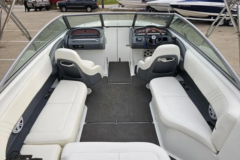 Slide: The Image of 2007 Cobalt 252 boat interior with white seating and modern dashboard design. - 54