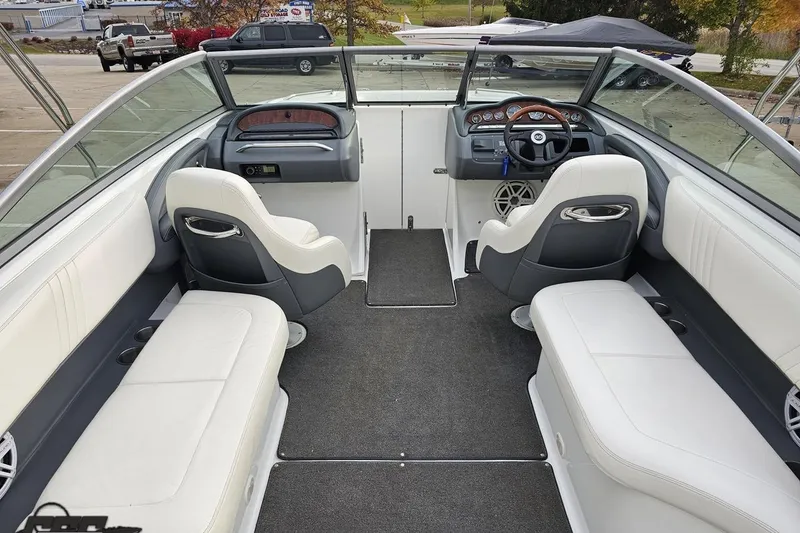 Slide: The Image of 2007 Cobalt 252 boat interior with white seating and modern dashboard design. - 56
