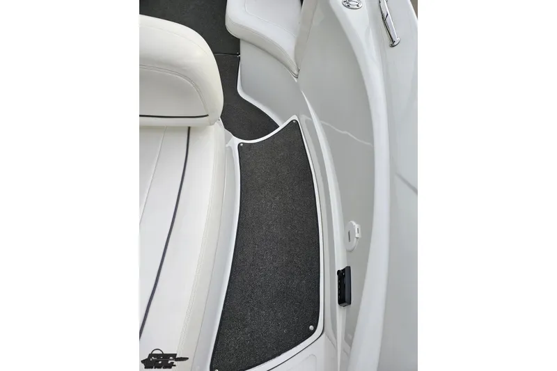 Slide: The Image of 2007 Cobalt 252 boat interior with white seating and dark carpet flooring. - 59