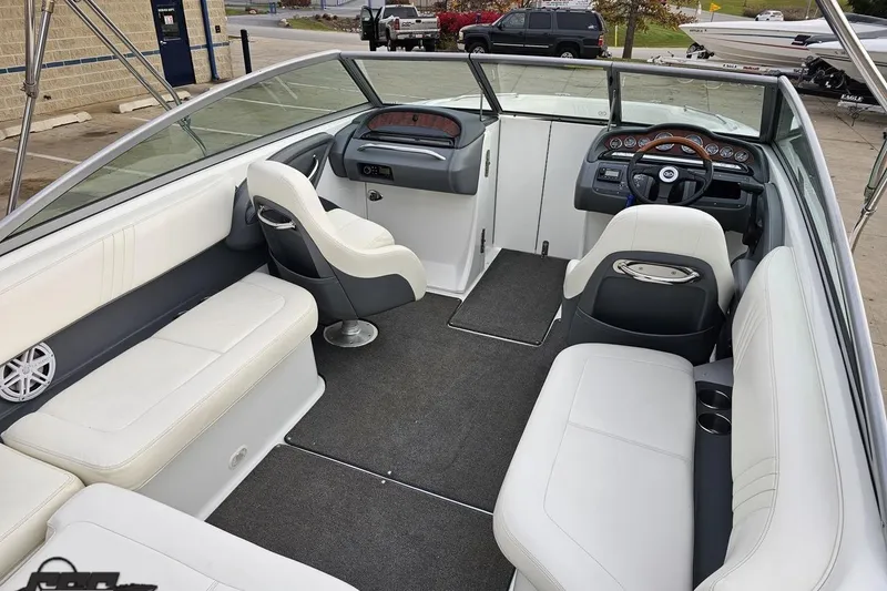 Slide: The Image of Interior of a 2007 Cobalt 252 boat with white seating and modern dashboard. - 61