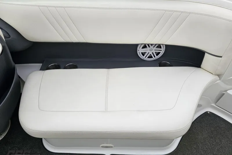 Slide: The Image of 2007 Cobalt 252 boat interior with white leather seating and built-in speaker. - 65