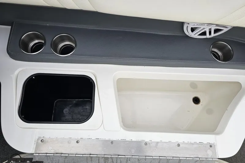 Slide: The Image of Interior of a 2007 Cobalt 252 boat featuring cup holders and storage compartments. - 66