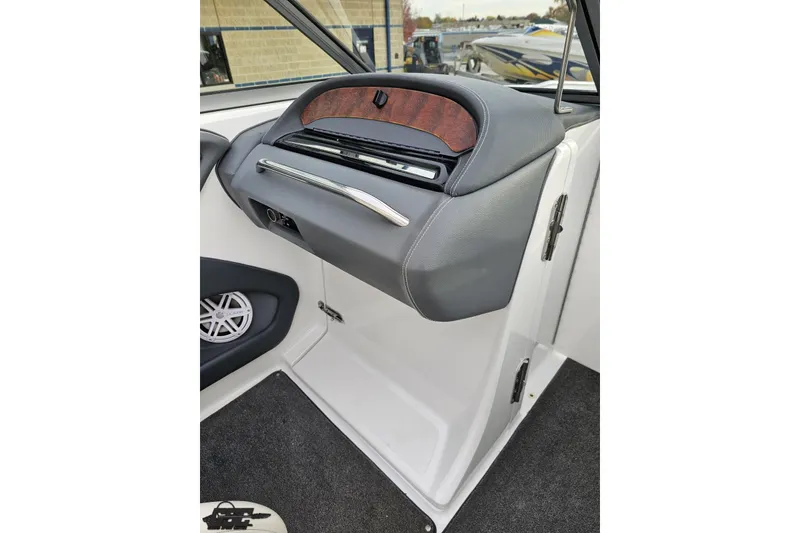 Slide: The Image of 2007 Cobalt 252 boat interior dashboard with wood accents and speaker. - 70