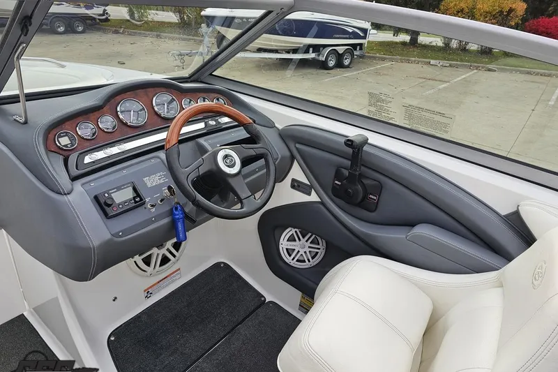 Slide: The Image of 2007 Cobalt 252 boat dashboard with steering wheel and control panel. - 79