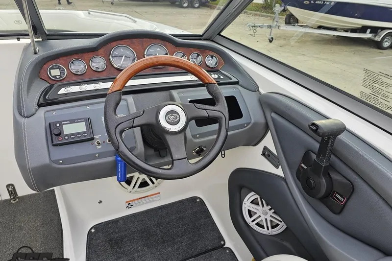 Slide: The Image of 2007 Cobalt 252 boat dashboard with steering wheel and control panel. - 80