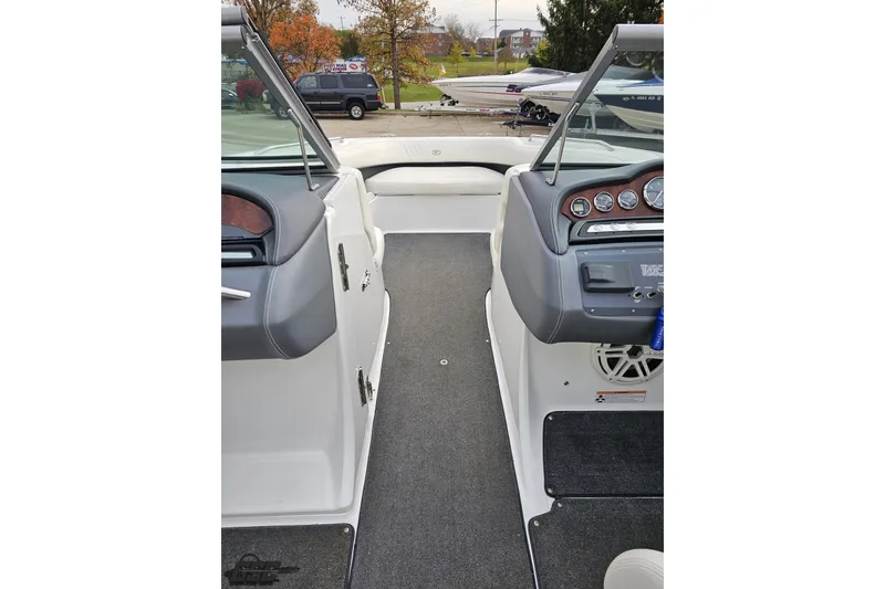 Slide: The Image of 2007 Cobalt 252 boat interior with dashboard and seating, parked outdoors. - 85