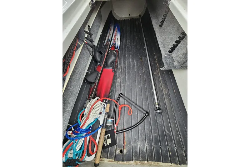 Slide: The Image of Storage compartment in a 2007 Cobalt 252 boat with water skis and ropes. - 86