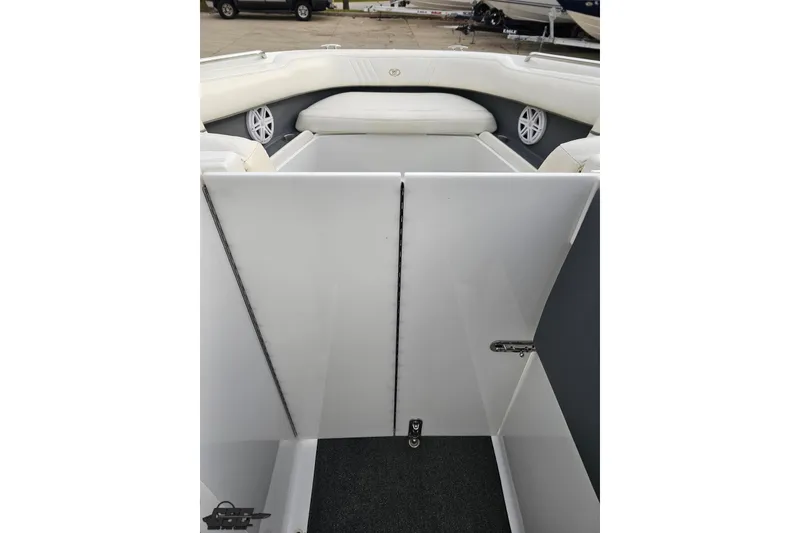 Slide: The Image of 2007 Cobalt 252 boat interior with white seating and storage compartment. - 87