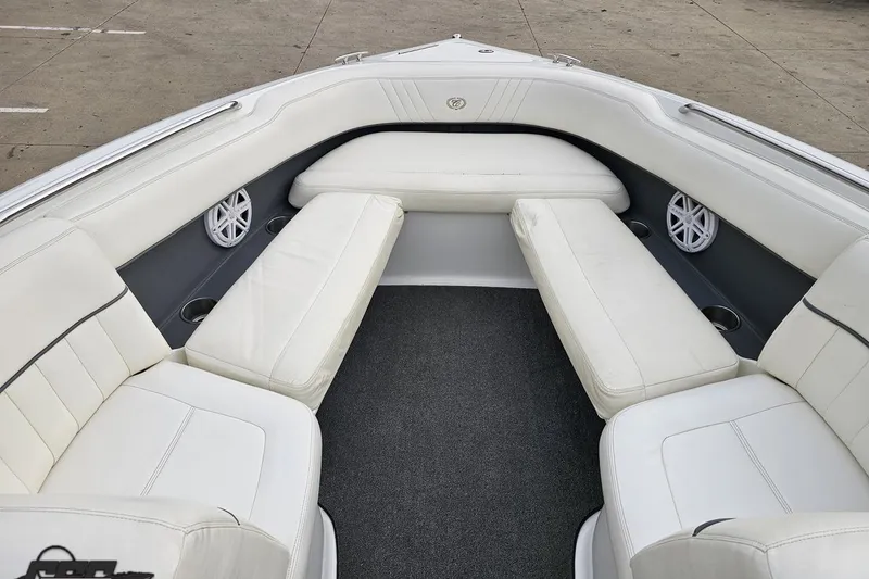 Slide: The Image of Luxurious white seating in 2007 Cobalt 252 boat interior, featuring cup holders and speakers. - 88