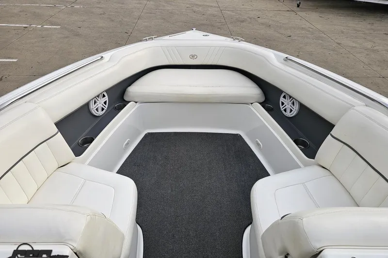 Slide: The Image of Interior of a 2007 Cobalt 252 boat with white seating and speakers. - 90