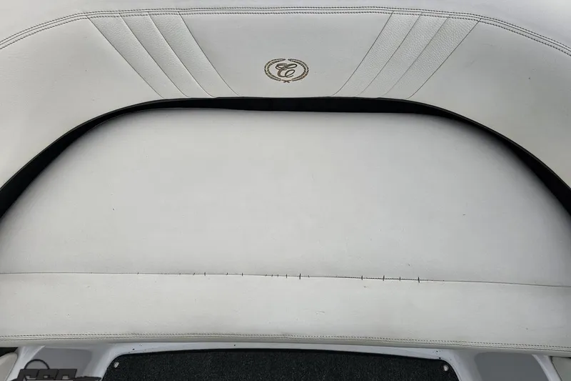 Slide: The Image of White leather seating on a 2007 Cobalt 252 boat, featuring elegant stitching and logo. - 97
