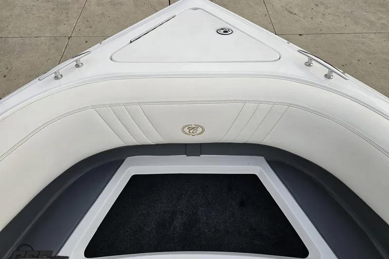 Slide: The Image of 2007 Cobalt 252 boat interior with white cushioned seating and storage compartment. - 98