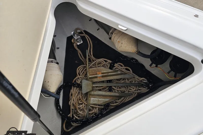 Slide: The Image of Anchor and rope storage in 2007 Cobalt 252 boat compartment. - 99