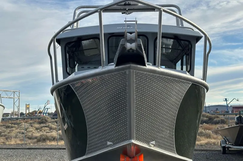 Slide: The Image of 2025 Hewescraft 270 Pacific Explorer boat front view, showcasing rugged design. - 3