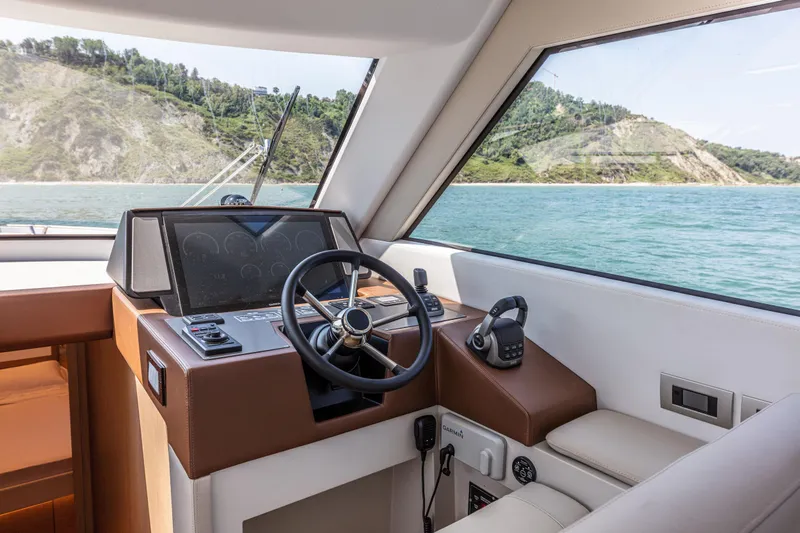 Slide: The Image of Interior helm of 2024 Solaris Power 48 Flybridge yacht with scenic ocean view. - 11