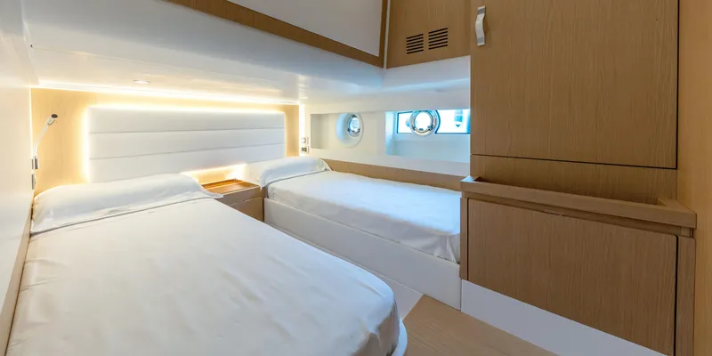 Slide: The Image of 2024 Solaris Power 48 Flybridge twin bed cabin with modern design and natural light. - 14