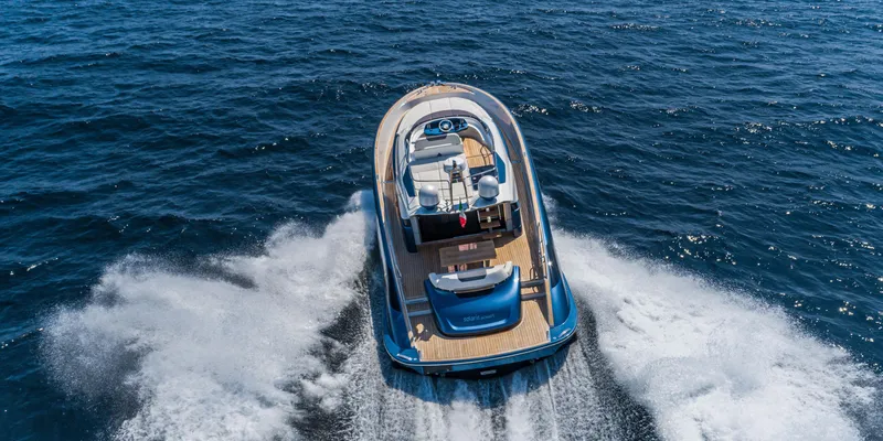 Slide: The Image of 2024 Solaris Power 48 Flybridge yacht cruising on open water. - 3