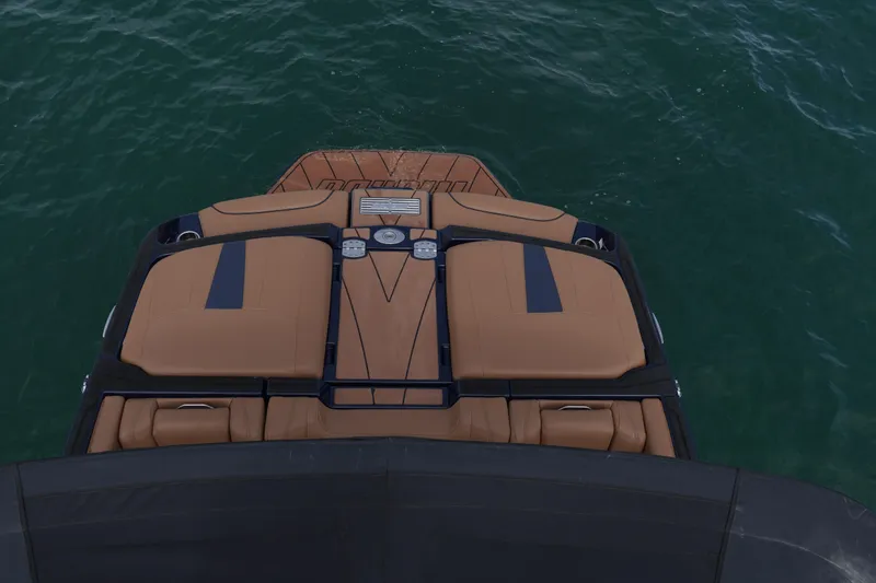 Slide: The Image of 2023 Malibu Wakesetter 23 LSV boat, rear view on water, featuring tan seating. - 13
