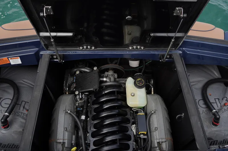 Slide: The Image of 2023 Malibu Wakesetter 23 LSV engine compartment, showcasing powerful inboard motor components. - 15