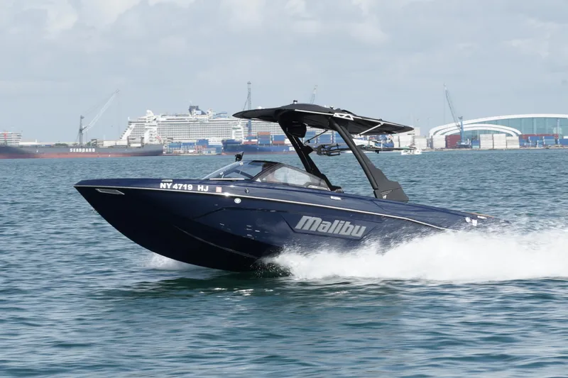 Slide: The Image of 2023 Malibu Wakesetter 23 LSV cruising in a busy harbor. - 20