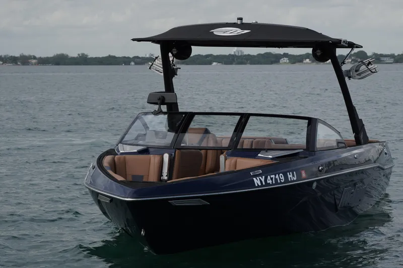 Slide: The Image of 2023 Malibu Wakesetter 23 LSV boat on calm water, featuring sleek design and modern amenities. - 21
