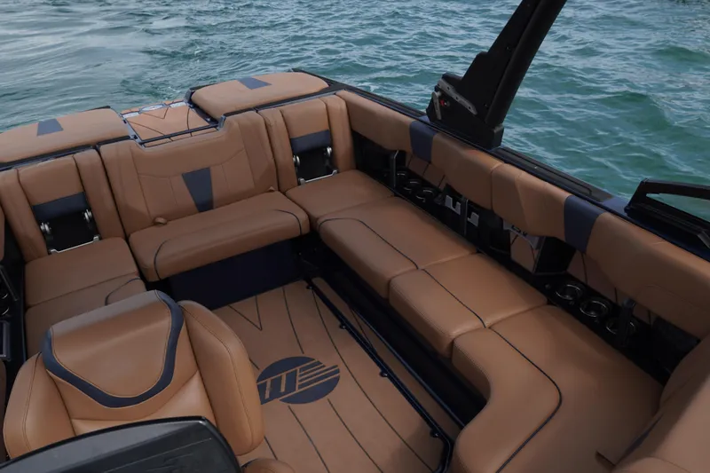 Slide: The Image of 2023 Malibu Wakesetter 23 LSV interior with tan leather seating on water. - 5
